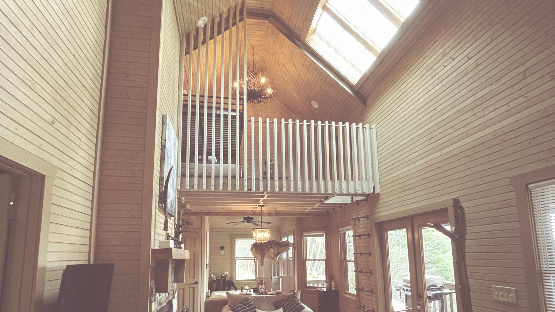 The modern loft and tall wood-paneled ceiling